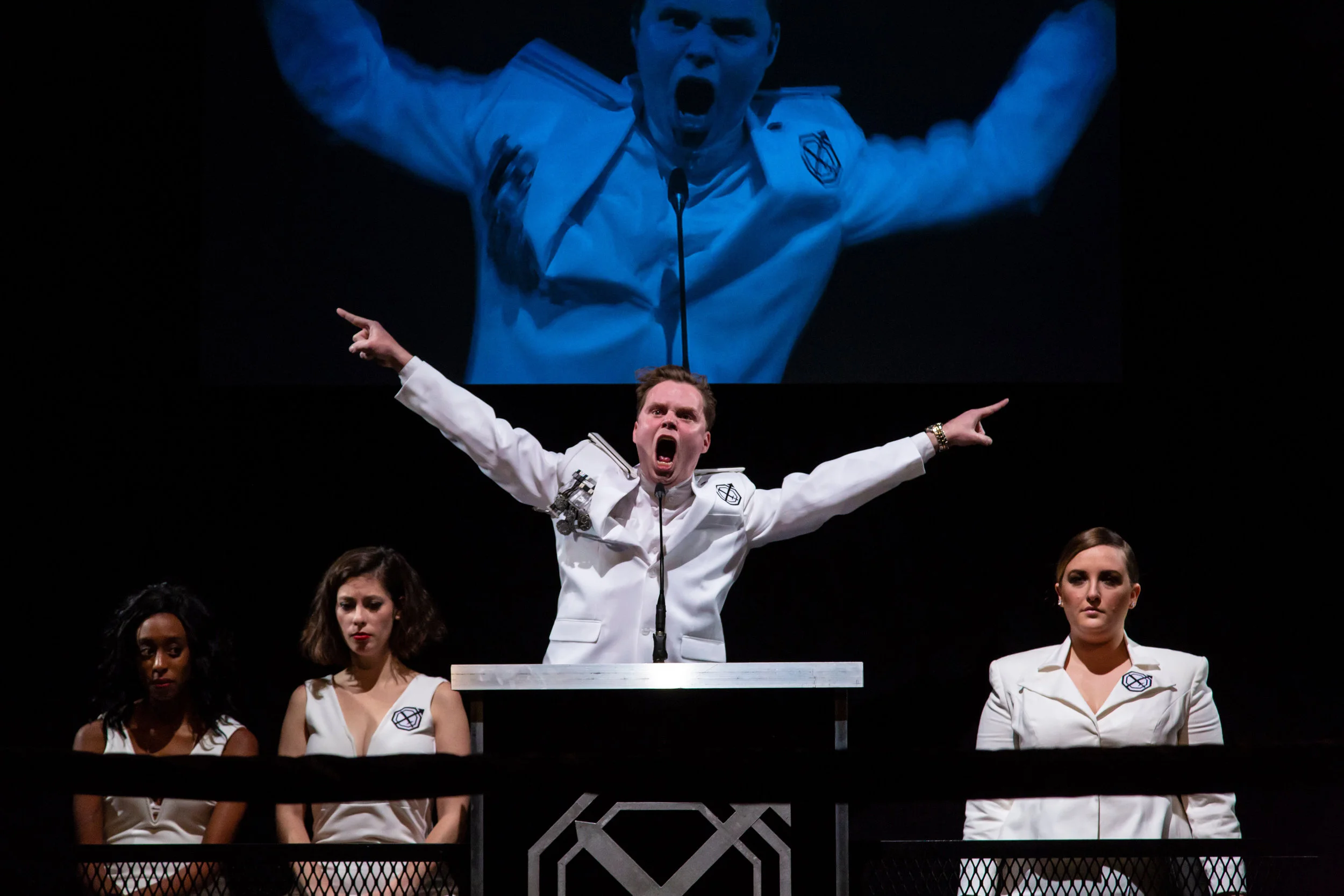 Duke Frederick (John Evans Reese, center), with Rosalind (Amandla Jahava), Celia (Eli Pauley), and Olivia (Zoe Mann) in shakespeare’s as u like it adapted by Emma Weinstein and Michael Breslin, directed by Emma Weinstein (Photo by T. Charles Erickson, 2018)