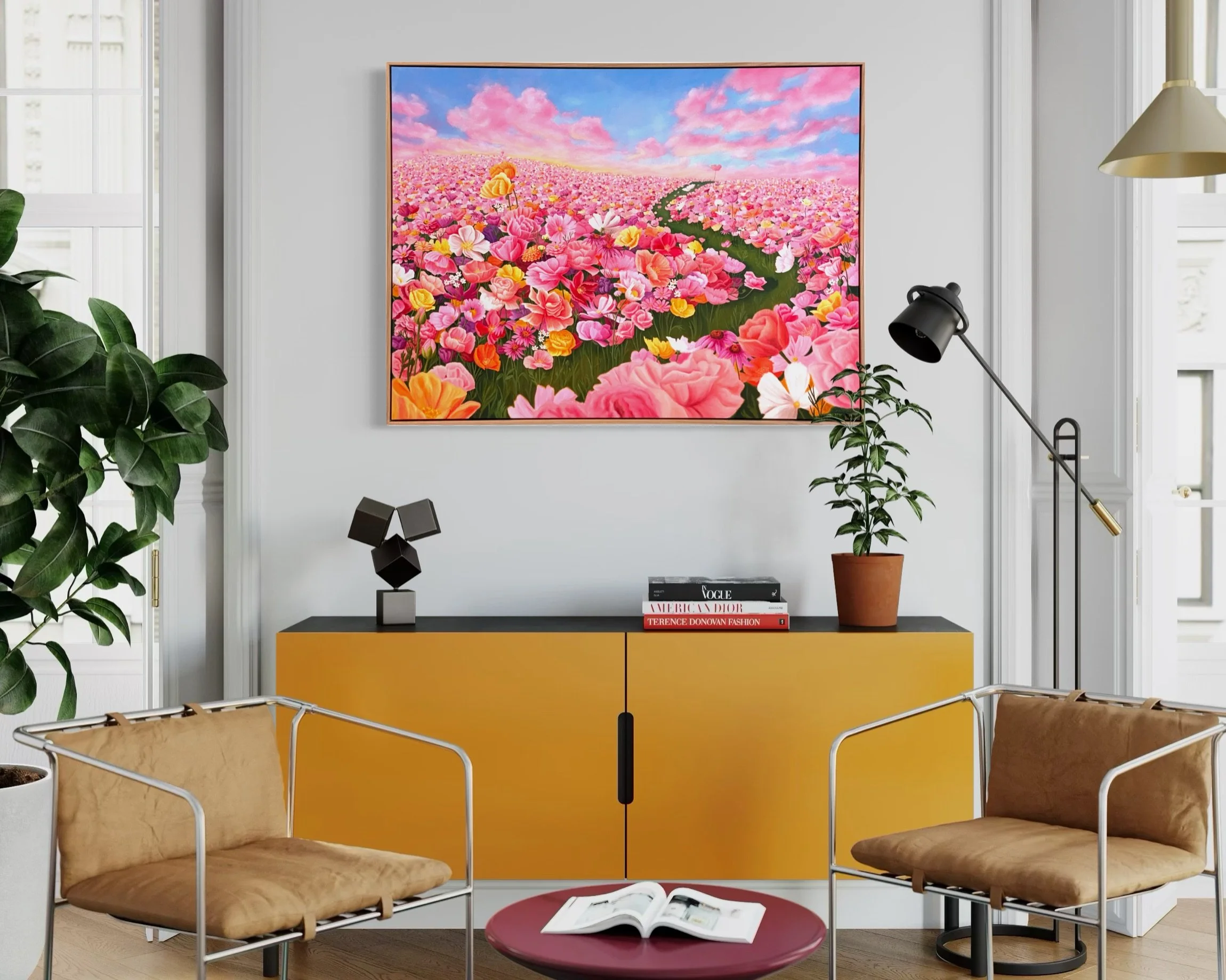 A pink floral painting hangs on a light pink wall above a yellow cabinet, with three decorative vases in red, blue, and reddish-brown on top of the cabinet. A shadow of a large plant is cast on the wall.
