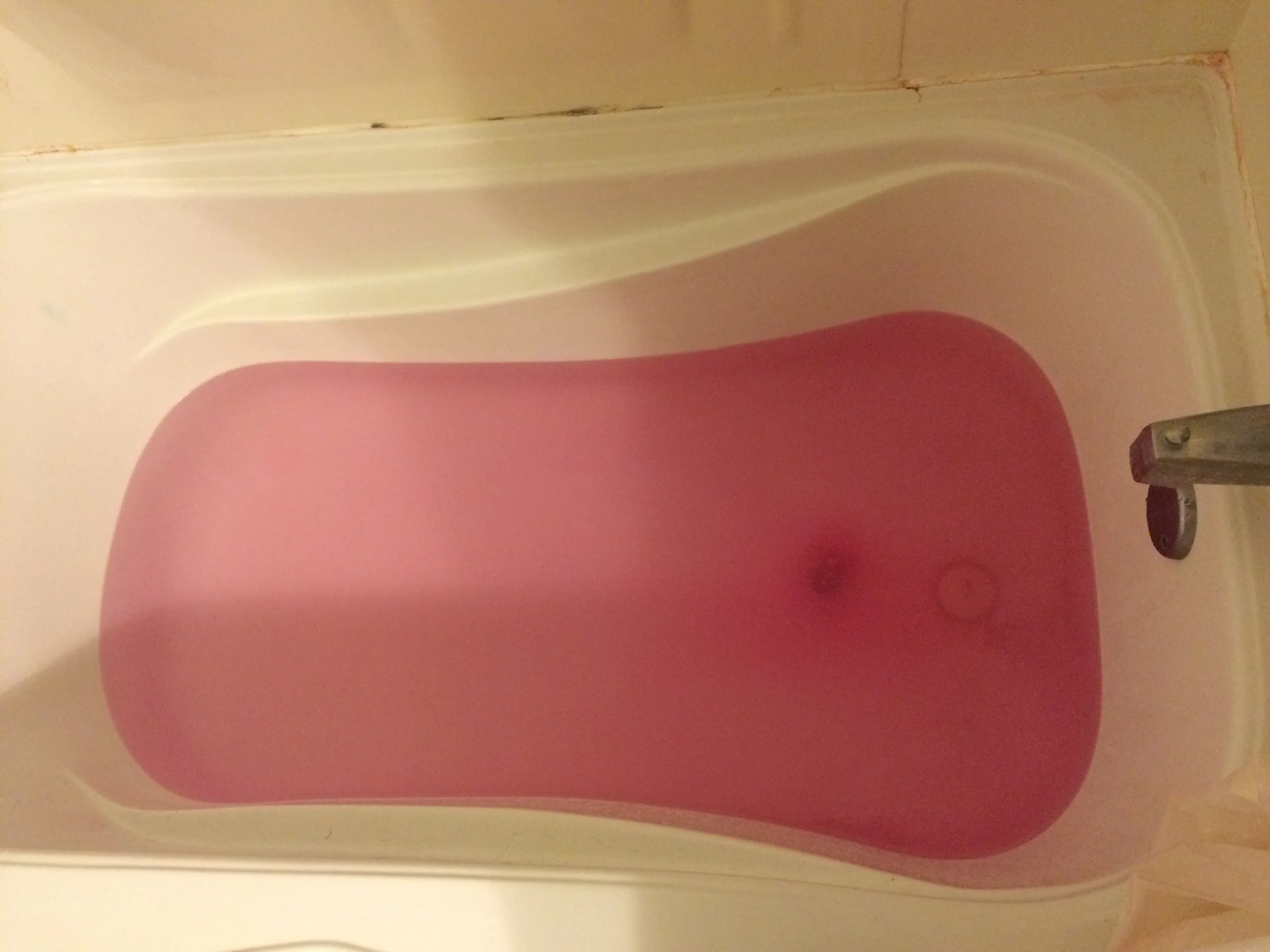 My mom got me bath bombs for Christmas because she's great! That's why the water is pink- that dark lump in the middle is the part that hadn't yet dissolved!