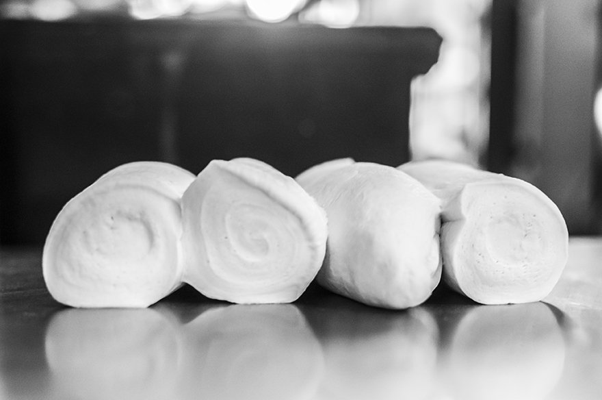 Mari works at a bakery through the job training program that Hagar provides to empower the survivors to be one step closer to being financially independent. Mari is completely work driven, unwilling to even take five minutes out of her workday to take a quick photo. She works quickly and precisely moving from side to side, cutting, kneading, and shaping the dough.