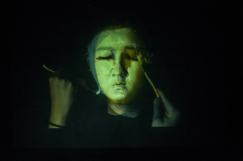 Hyphen (self-portrait) Multimedia installation: projection, sound, television, DVDs in a constructed room 96x125x96 inches. 1/7 screens documented. 