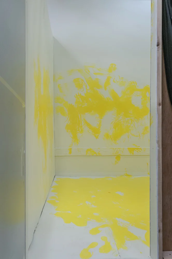 Marking. Multimedia installation: yellow paint, oriental kimono, Coverall, googles, face mask, paint can, paint opener, documented performance, and television sets. 96x125x96 inches. Installation view.