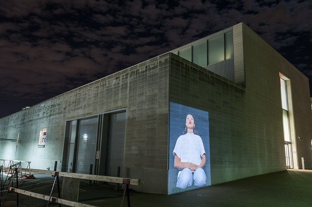 I Am Kneeling. Public art installation of a 132 x 96 inch projection on the facade of Walker Hall at Washington University at St. Louis. Installation view. 