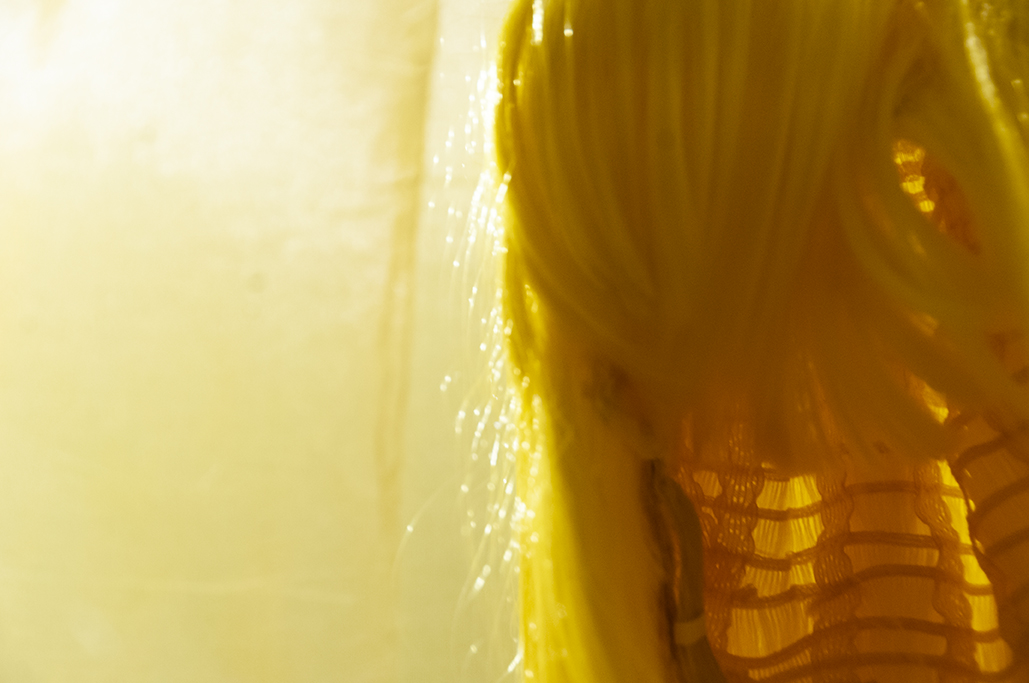 Is this | This is… Multimedia installation: yellow curtains, old television, copy of Native Speaker by Chang Rae Lee, wig, 20 packs of rectangle dan moo ji, 5 packs of circle dan moo ji, print, shag rug, scrabble letters. 120” x 240” x 240” Detail.