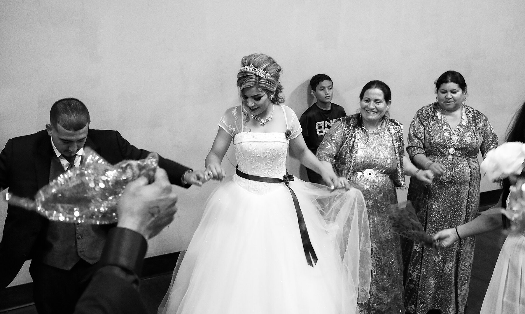  Women wear traditional dresses and everyone joins in a shoulder-shaking shingaly dance on a Yazidi couple’s wedding day. Lincoln, Nebraska, 2017. 