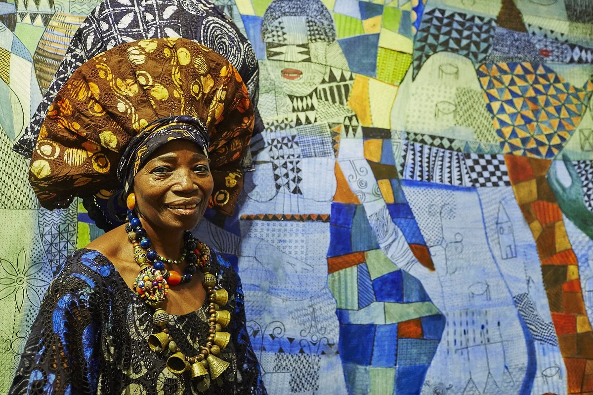 MRS NIKE OKUNDAYE WITH SOME OF HER ARTWORKS