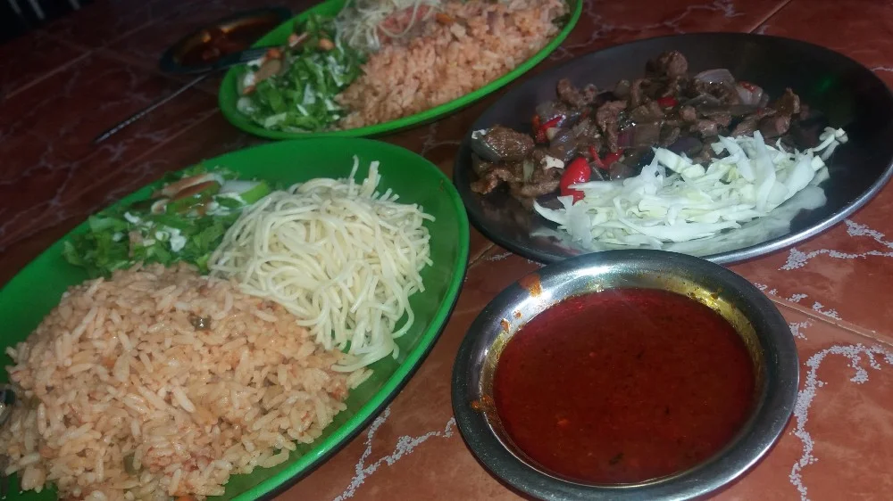 Jollof Rice, Spagetti, Salad and Diced beef, served with Spicy Sauce
