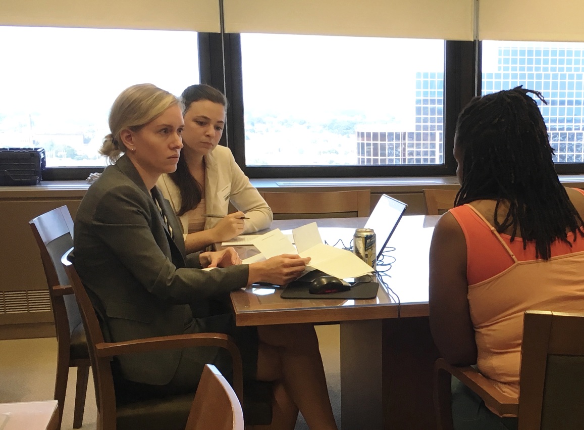 Kate Petrie sits with one of our volunteer attorneys at an expungement clinic