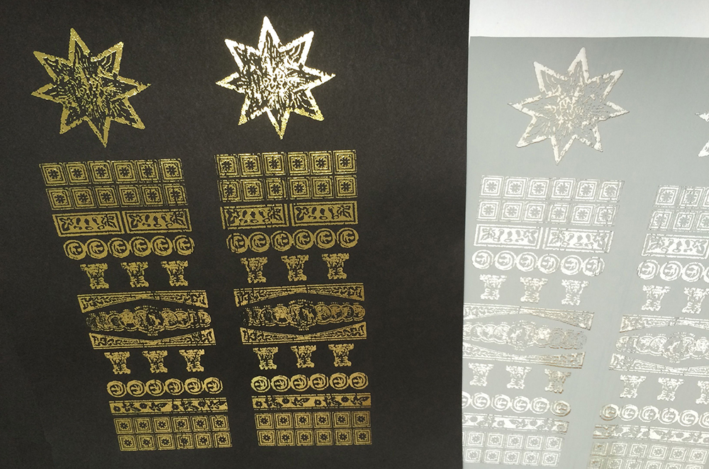 Gold foil heat transfer – laser printing black ink onto black paper and then running it through a laminator with the foil.