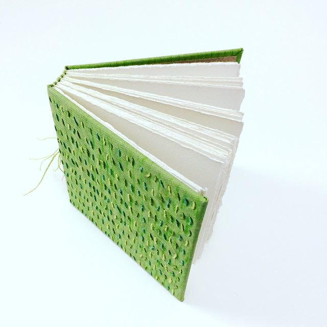 Multi-section book with embroidered cover
