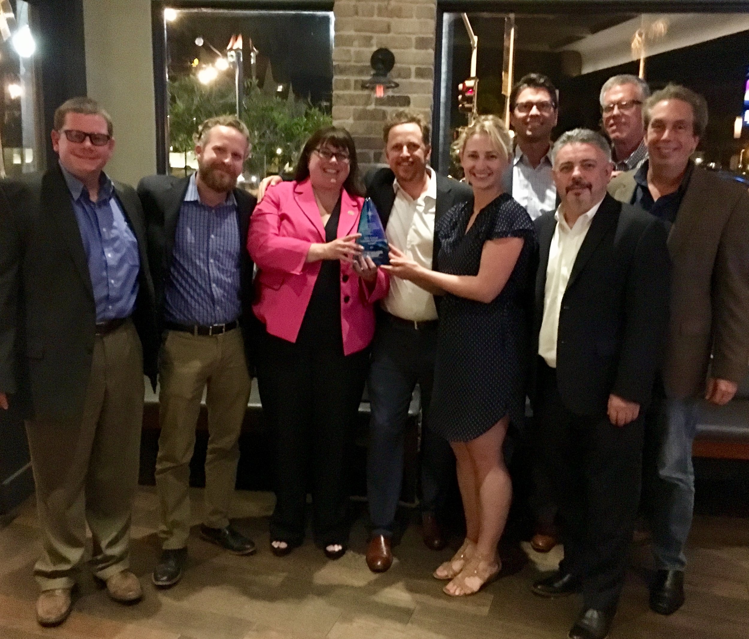 NASRC board members Clay Rohrer, Tristam Coffin, Keilly Witman, Aaron Daly, Todd Washburn, Bryan Beitler, Peter Narreau and Peter Dee pose with the award of the most recent board meeting.