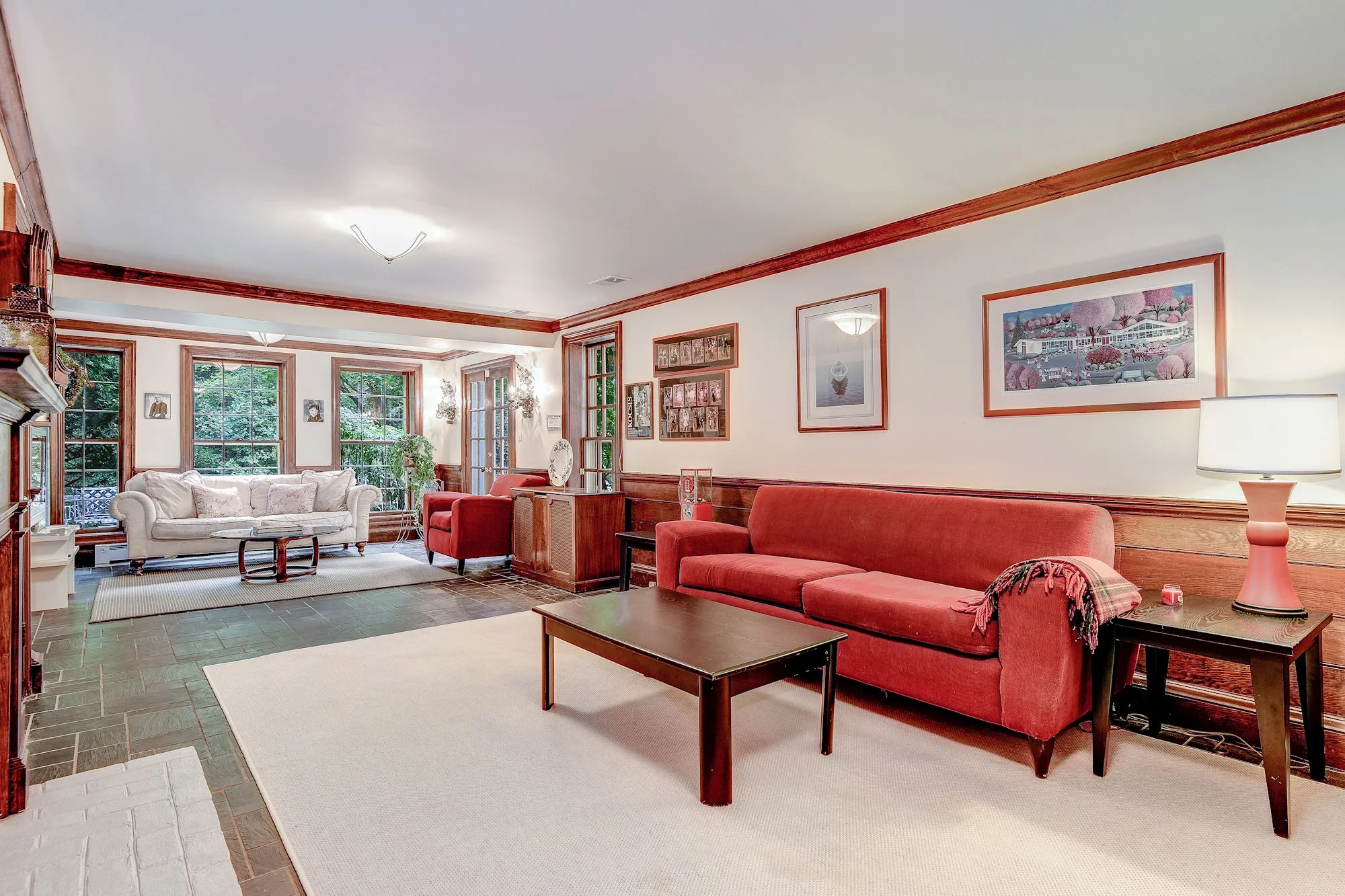 The Family Room offers a handsome slate floor, fireplace and access to the outdoors
