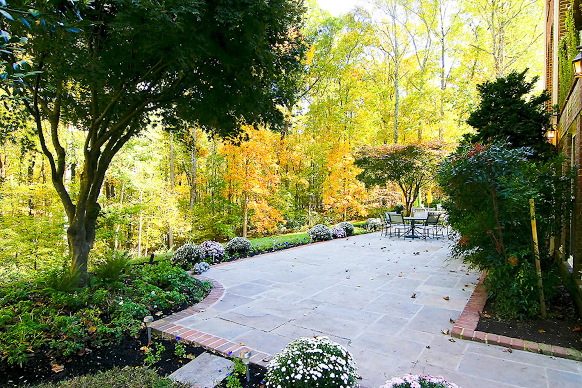 Flagstone and brick Terraces embrace the residence and the professional landscapes that feature in-ground irrigation