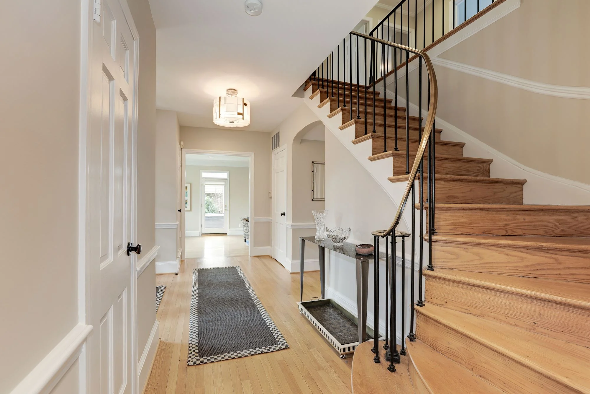 Entry Foyer with gracious curved stairway & three closets
