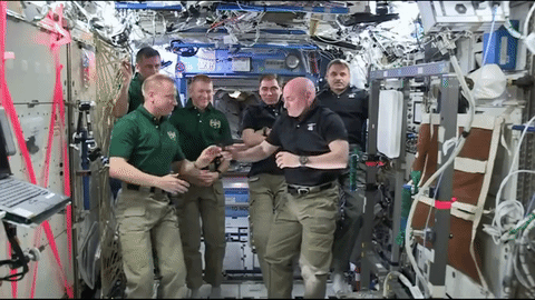 Astronaut Scott Kelly (right foreground) hands over command of the International Space Station to astronaut Tim Kopra (left foreground) with their crewmates in the background. Credit: NASA TV