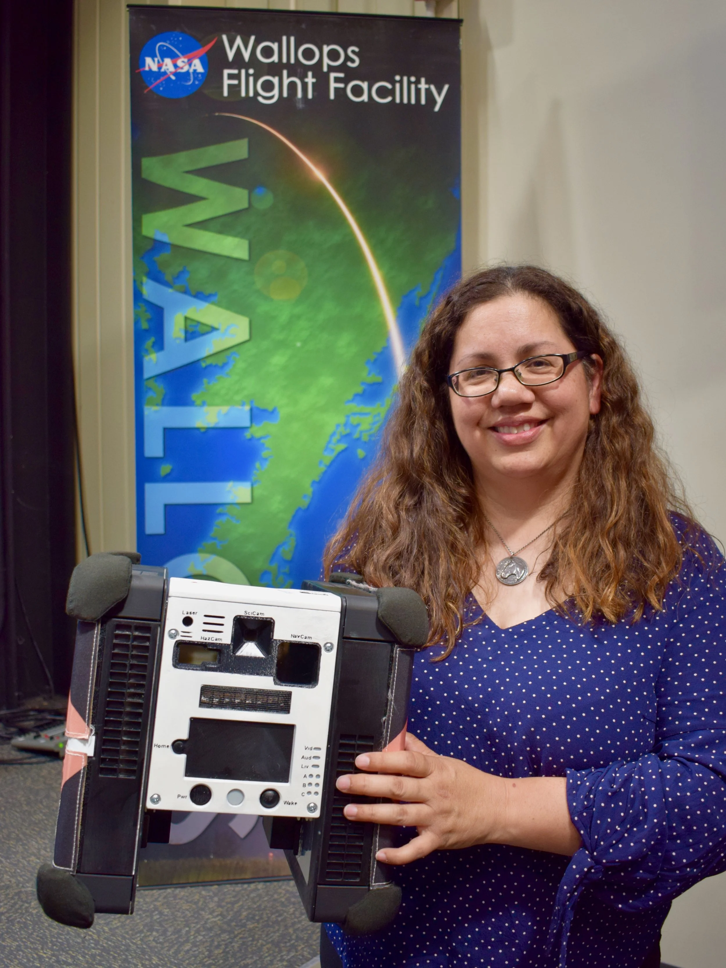 NASA IRG Deputy Group Lead Maria Bualat holds a demo Astrobee at Wallops Flight Facility. Photo credit: Josh Dinner/theOrbital.space