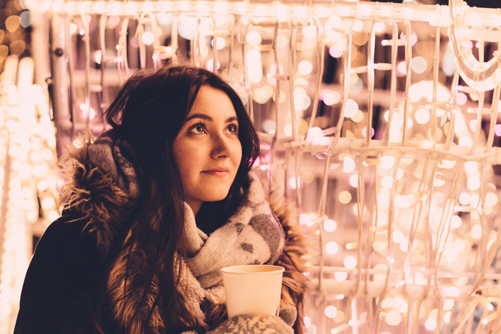 christmas_lights_and_girl_holding_coffee.jpg