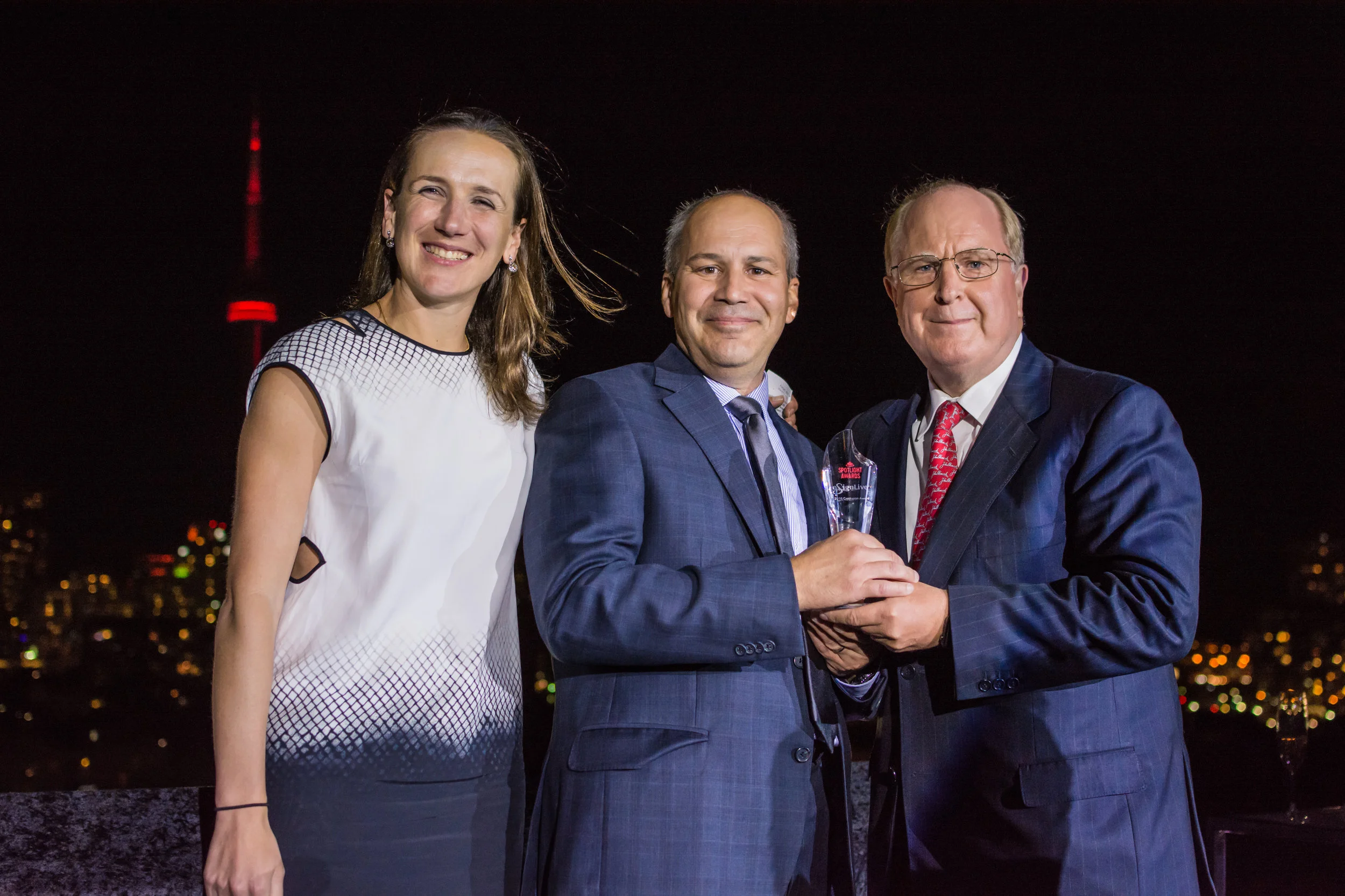 Co Chair Angela Strange, Partner at Andreessen Horowitz and Manulife CEO Don Guloien present an award to Tommy Petrogiannis, Co-founder of ESignLive