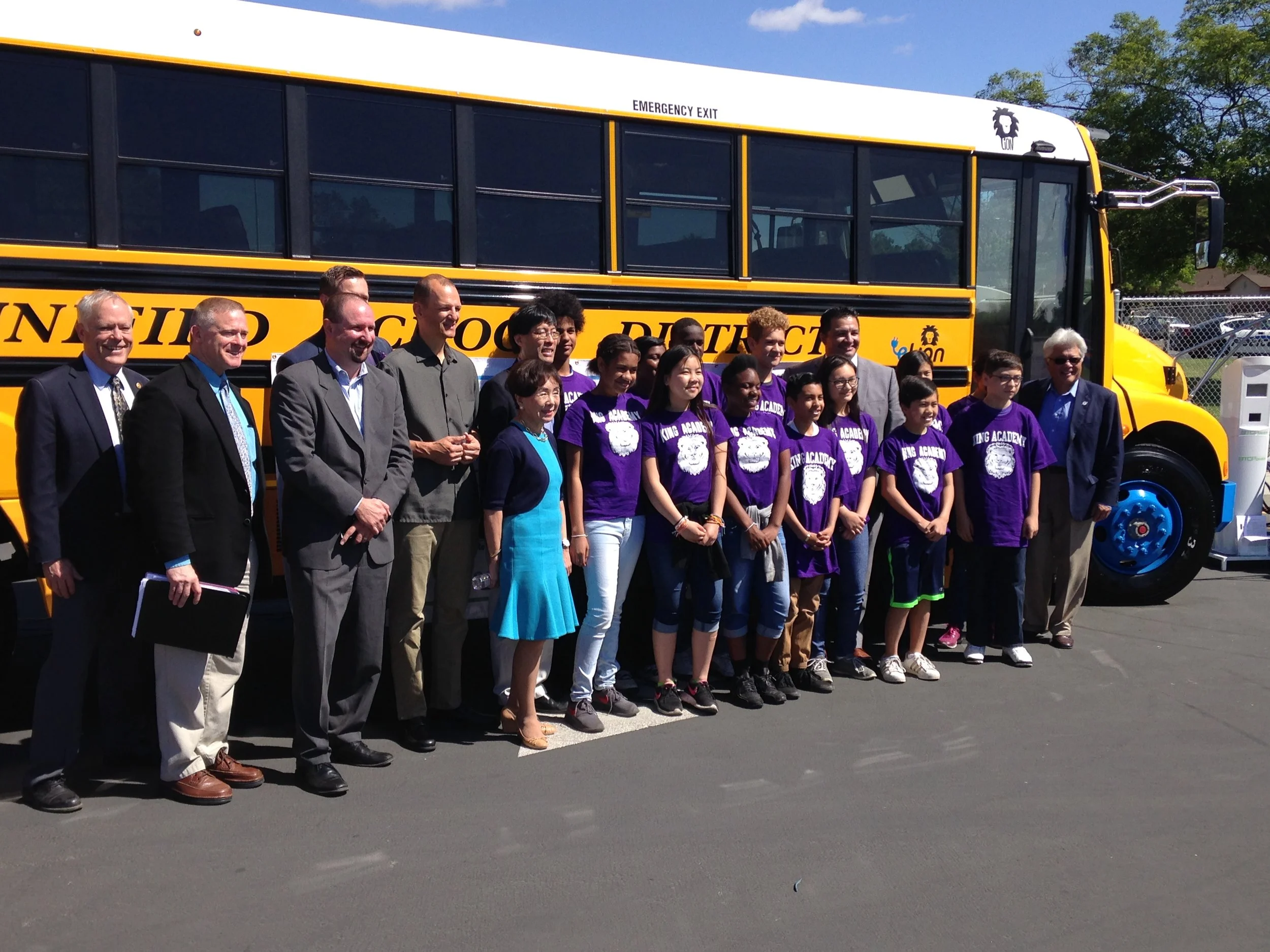 School children and administrators with electric bus