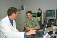 Dr. David Gnewikow assisting a young man