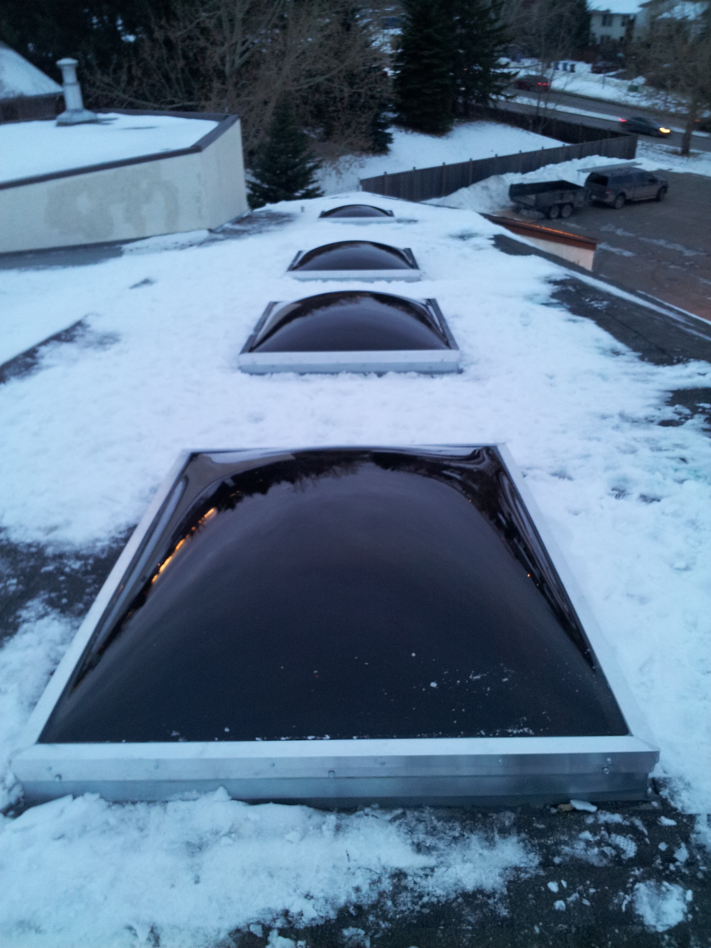  Oversized bronze acrylic domed skylights installed on a church. 