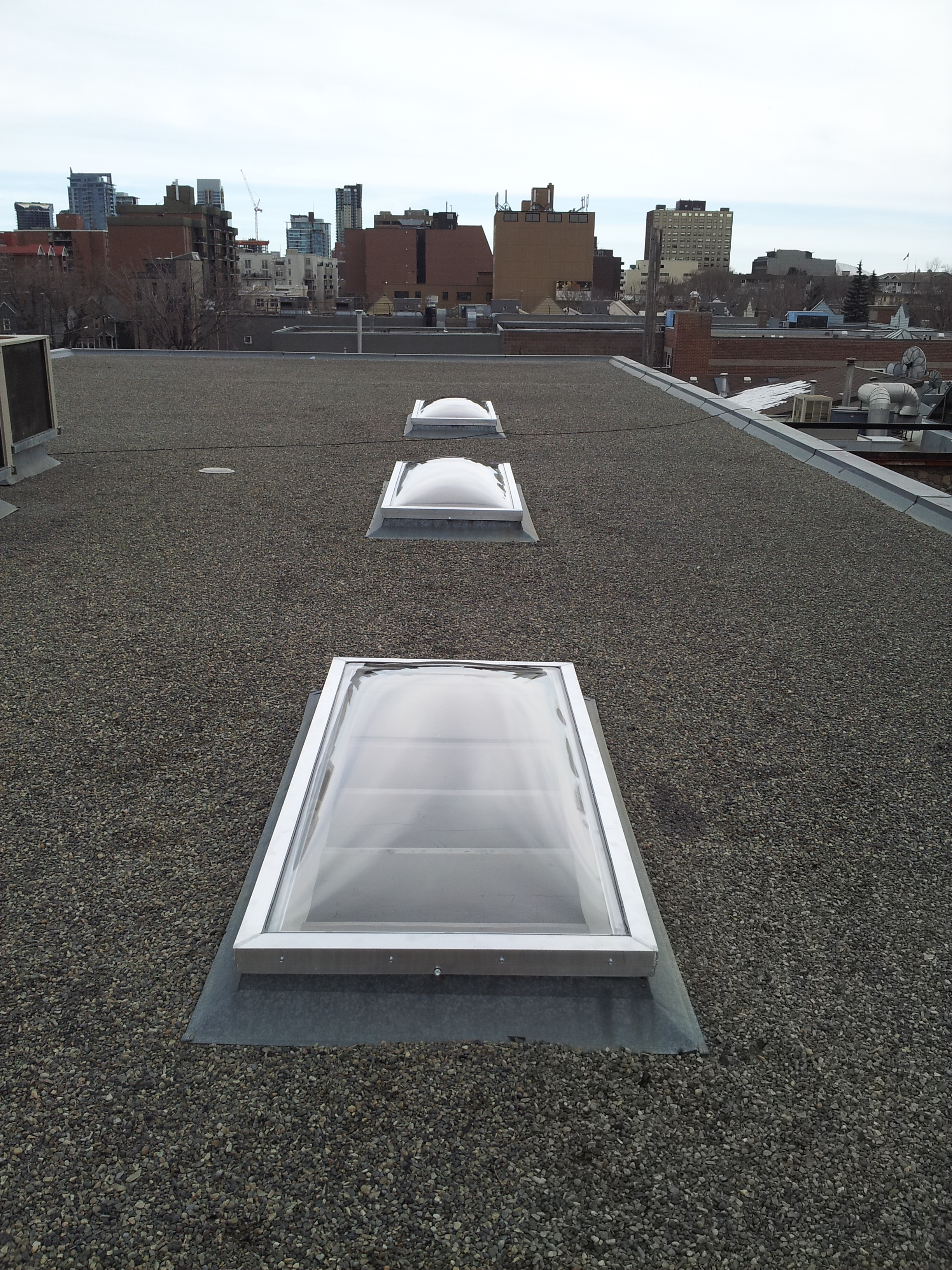  Curb mounted acrylic skylights installed over an art studio downtown. 