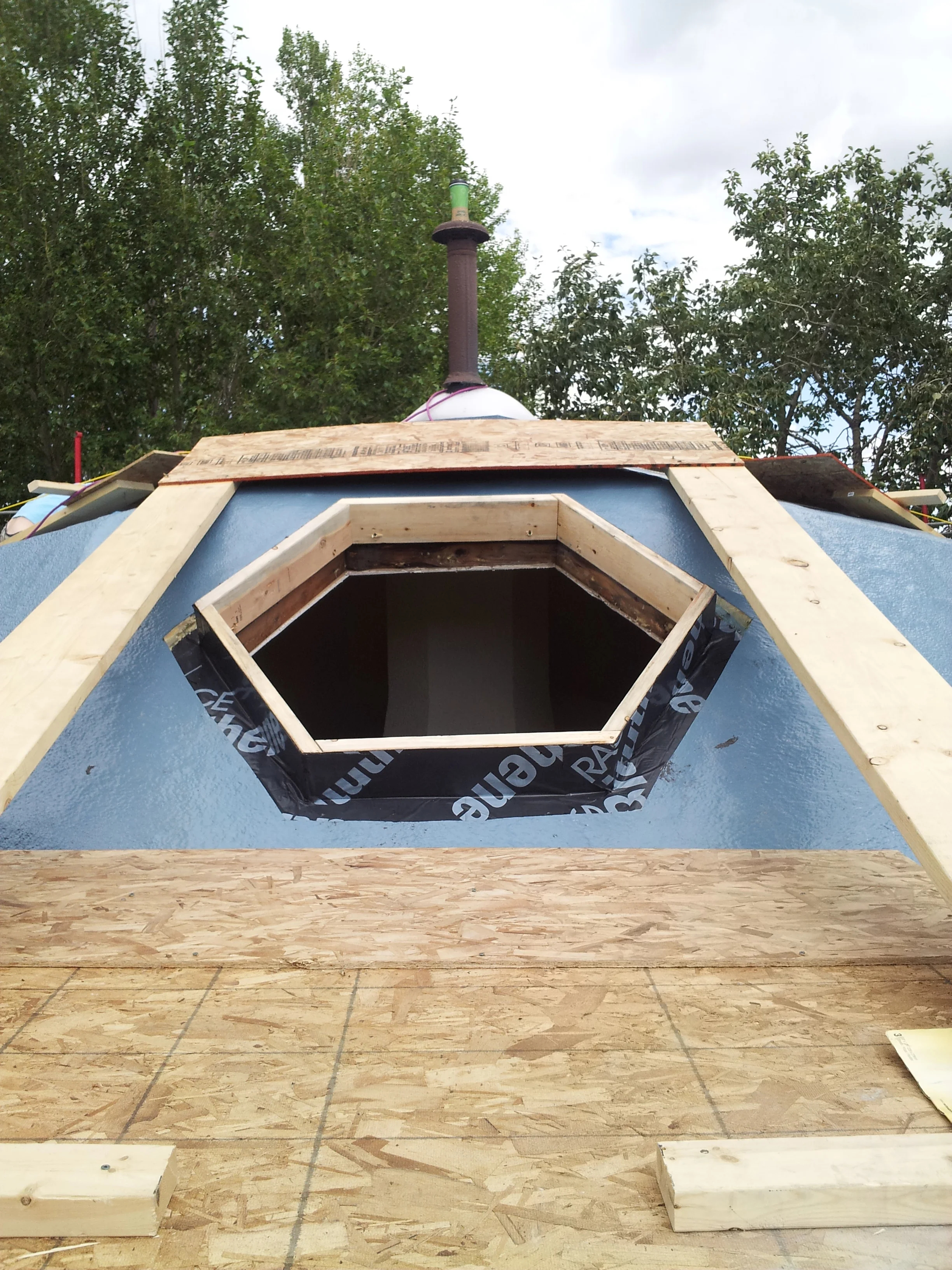  Using the platform we constructed another series of platforms to gain access all the way around. We built a new curb and wrapped it in membrane. 