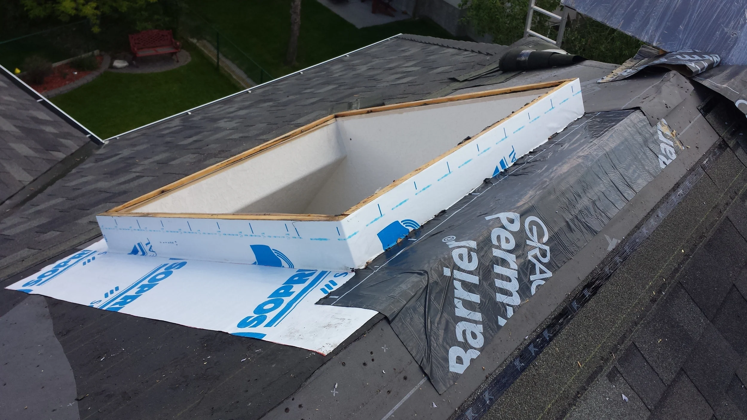  Membrane installed on a skylight. An additional piece of membrane was added at the peak of the roof to provide a good overlap on both sides. 