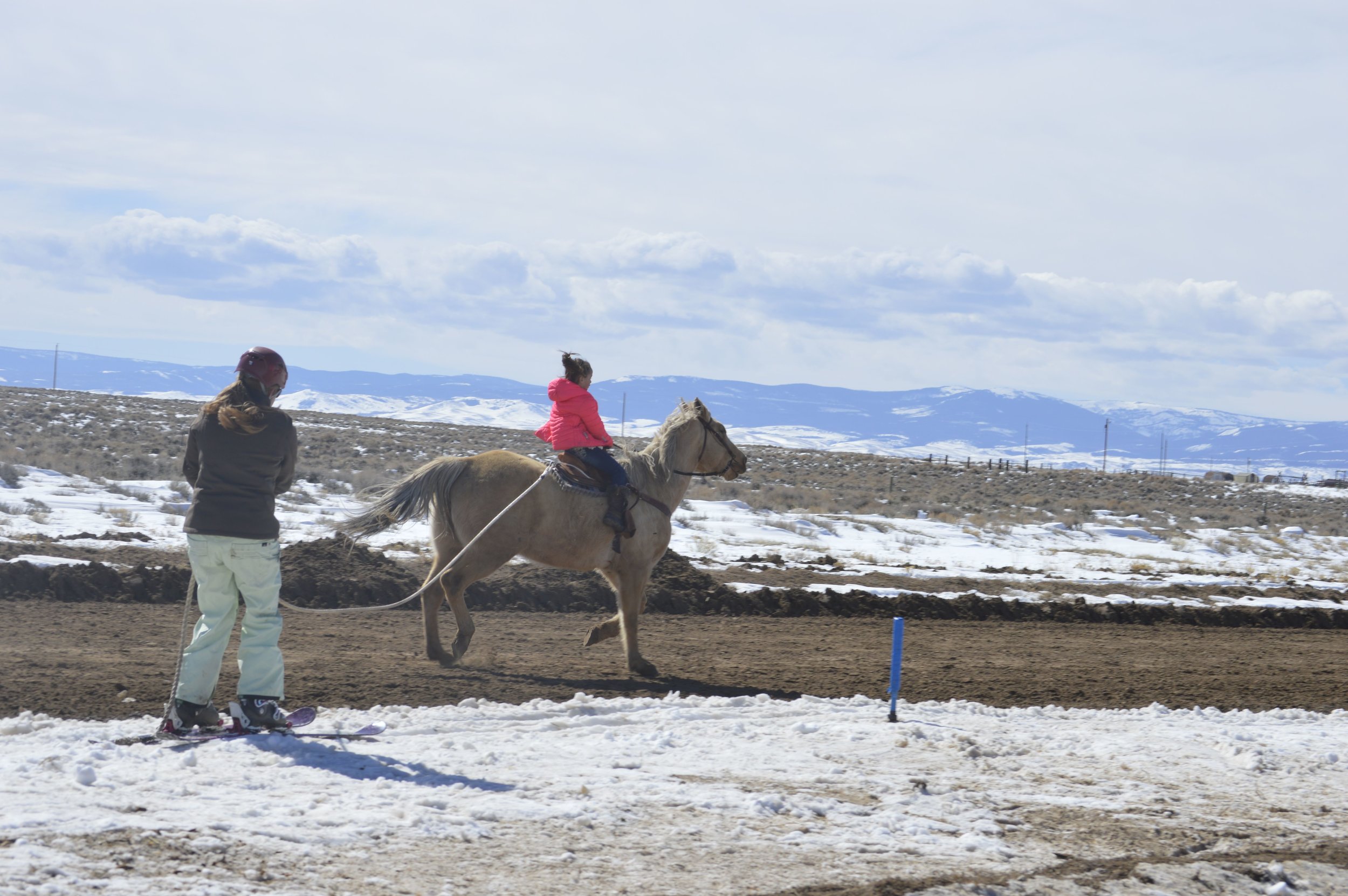 Karl’s wife Christy helps out a future skijoring rider!