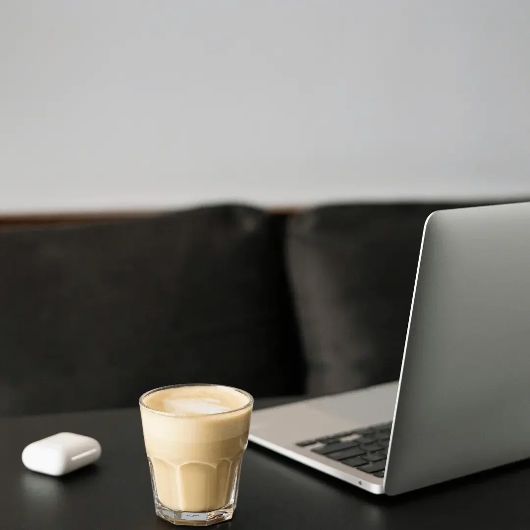 female entrepreneur branding Indoka Creative - computer on a table with a glass of chai latte