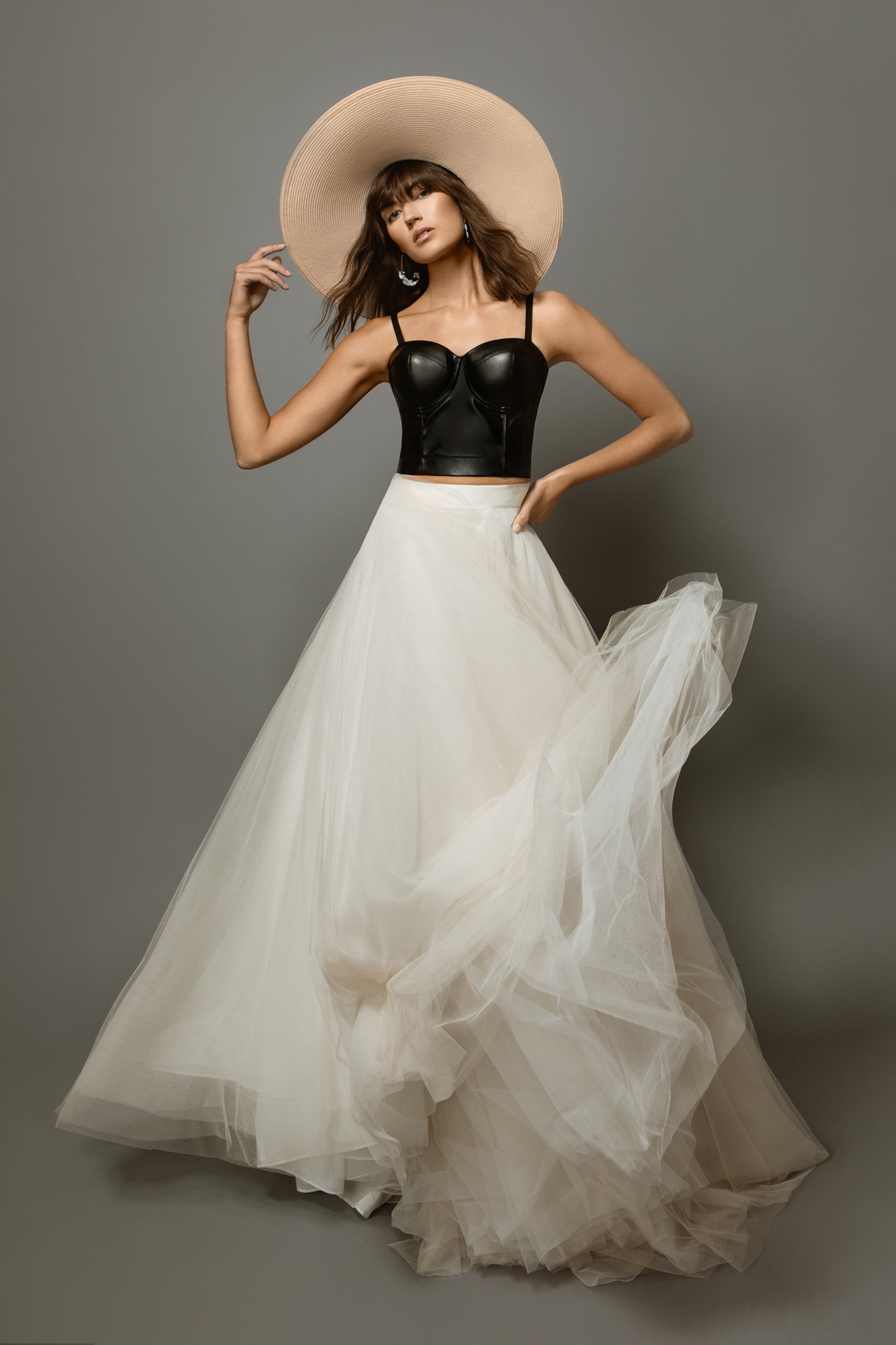 In studio fashion portrait of Pittsburgh model wearing a white flowy skirt and large hat