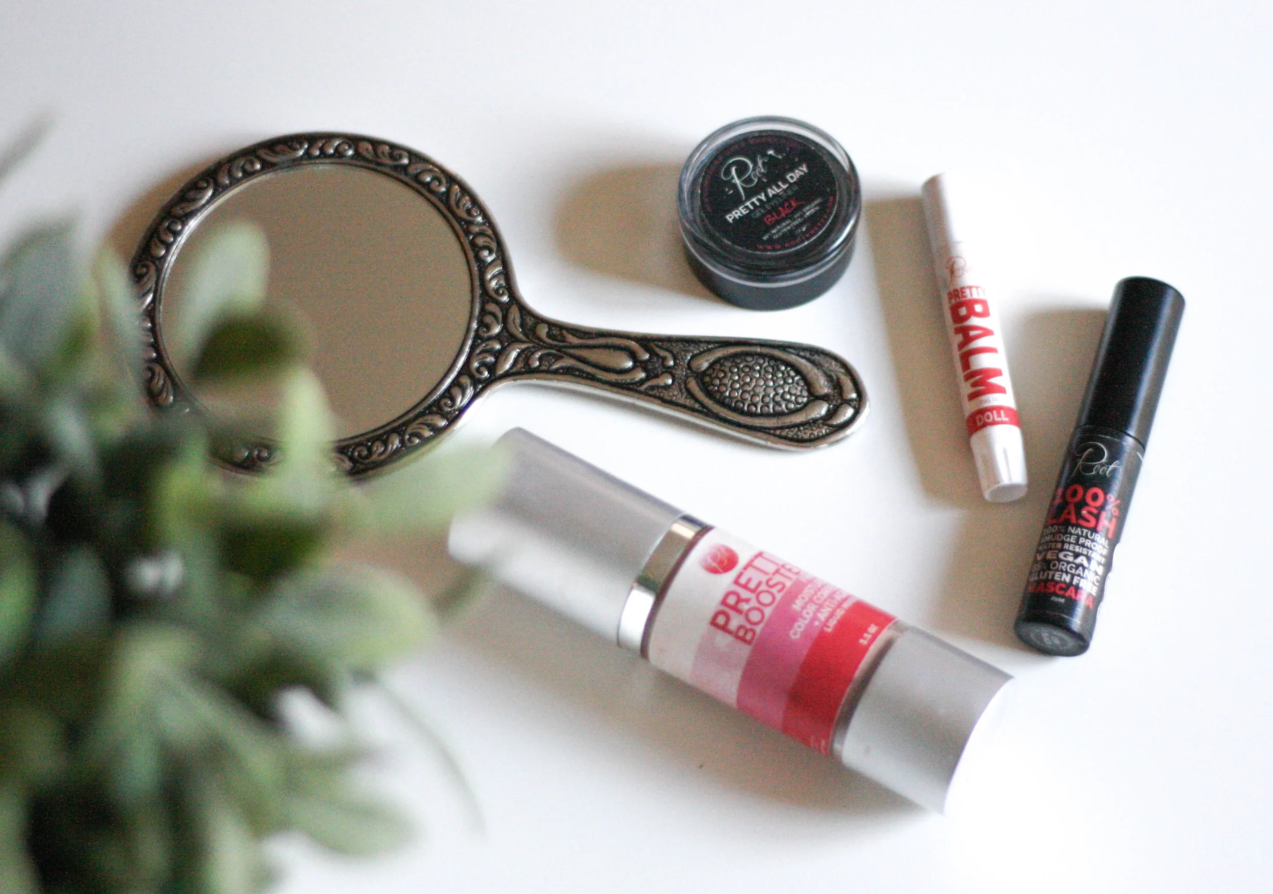 Pretty Booster, 100% Lash mascara, Doll pretty balm, + Pretty All Day gel eyeliner, above.