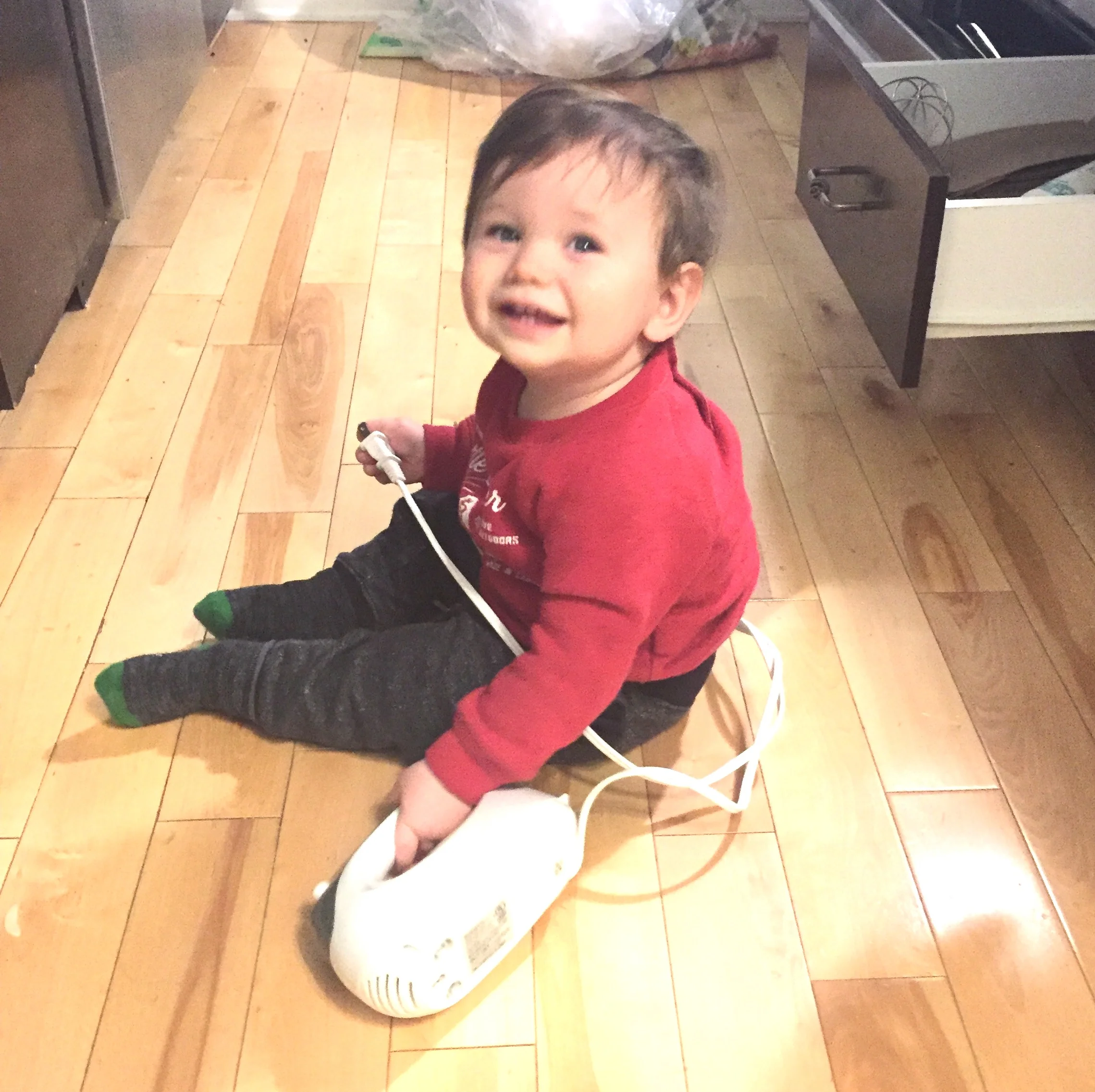 Owen sneaking into the baking drawer, ready to help with the 7 minute frosting and chocolate cake.