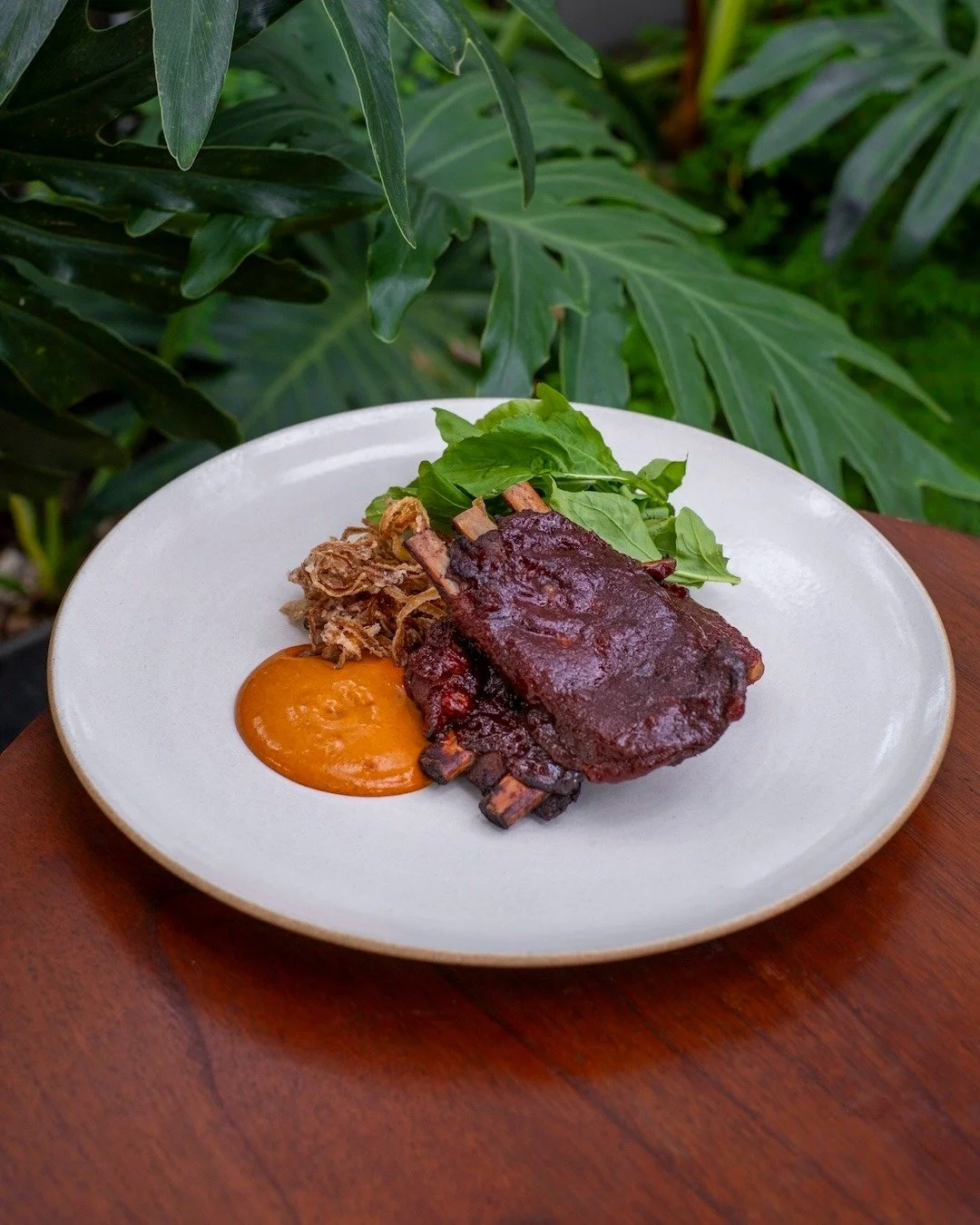 Cajun heat, jungle breeze. Fall-off-the-bone pork ribs, crispy onions, and that zesty Cajun emulsion &mdash; best enjoyed above Ubud&rsquo;s rooftops. 🌶️🌿 #UbudEats #APerfectBite

CAJUN PORK RIBS
crispy onion, rocket salad, cajun emulsion
+ d i n n