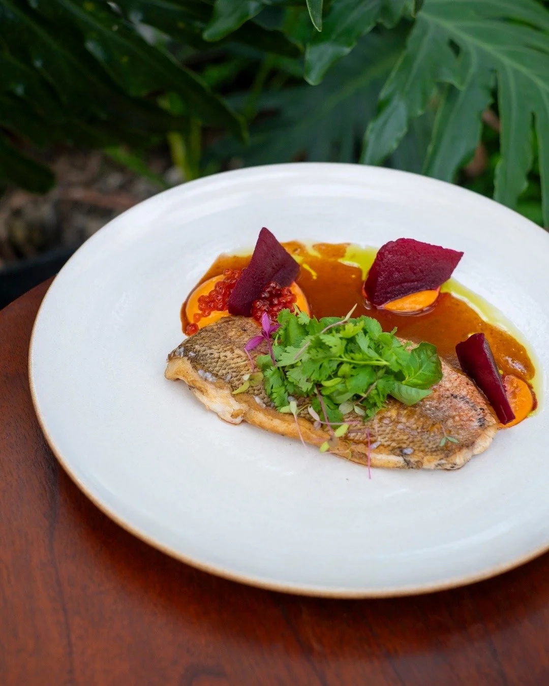 Light, bright, and beautifully balanced &mdash; Nusa Snapper with a citrusy lift and a pop of roe. Fresh flavors, golden hour energy. 🌊☀️ #UbudEats #APerfectBite

NUSA SNAPPER
tomato emulsion, herb oil, pickled beetroot, cured egg, salmon roe
+ d i 