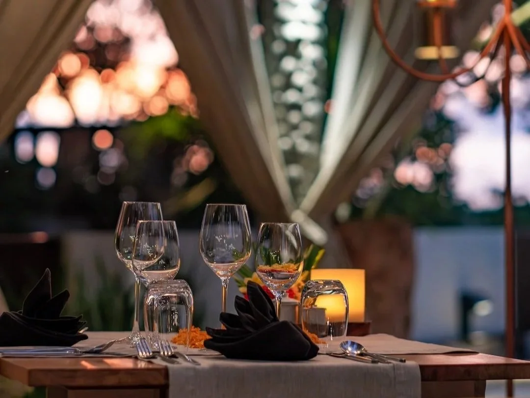 dinner rooftop setting with a few wine glasses on the table at sunset time