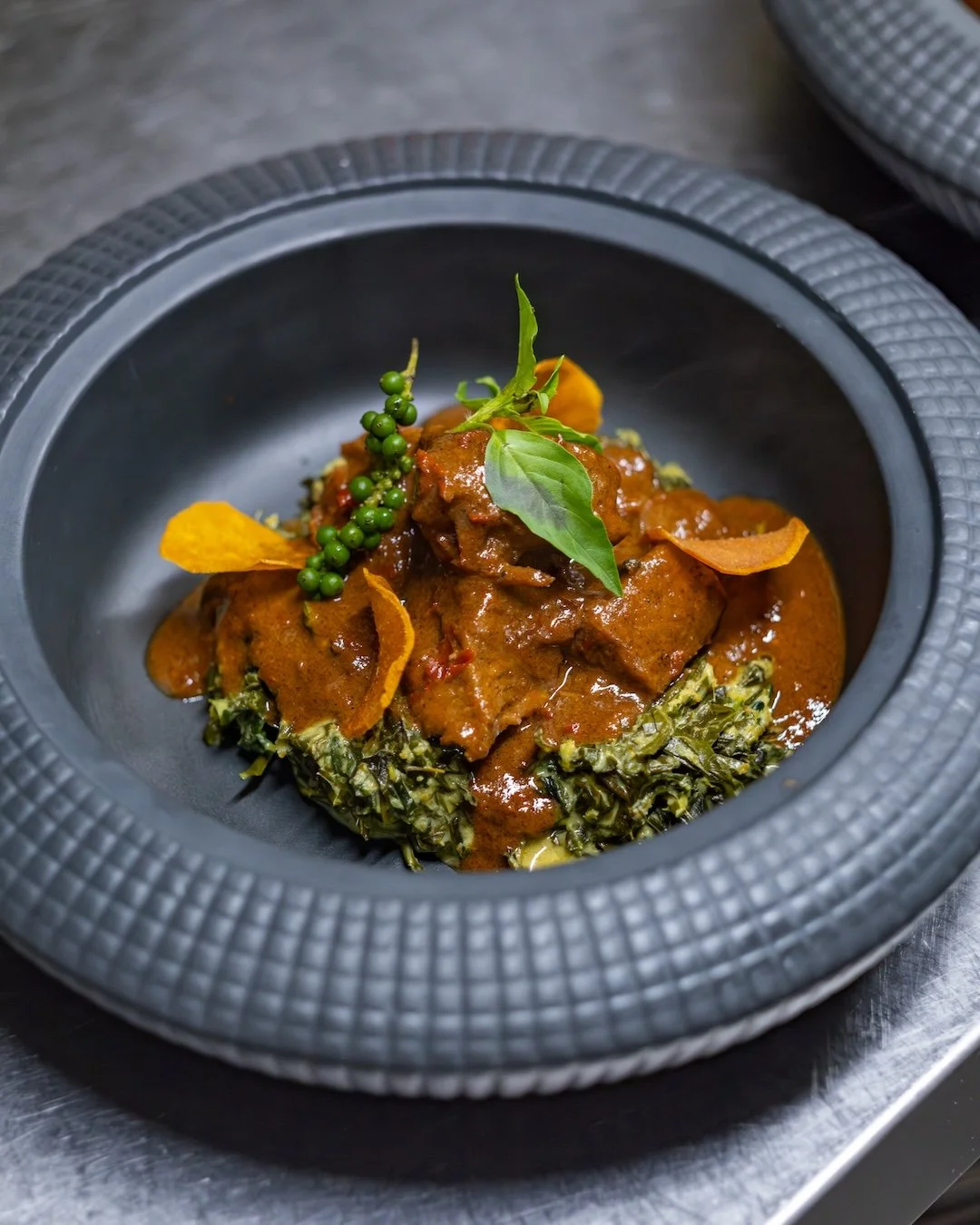 Some dishes become legendary for a reason.

Our Rendang is a celebration of Indonesia's rich culinary heritage, featuring tender meat slowly infused with fragrant spices and coconut-based flavors that develop over hours of careful preparation. One bi