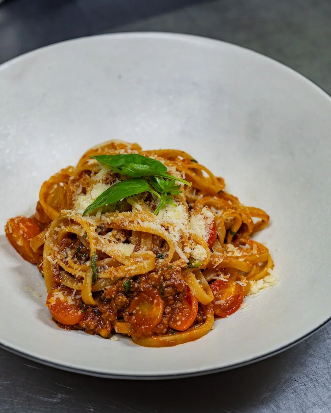 Some dishes are meant to feel like home.

Our Fettuccini al Rag&ugrave; brings together slow-simmered beef rag&ugrave;, ribbons of fresh fettuccini, fragrant basil, and a generous finishing of Grana Padano. Simple, comforting, and full of depth, it's
