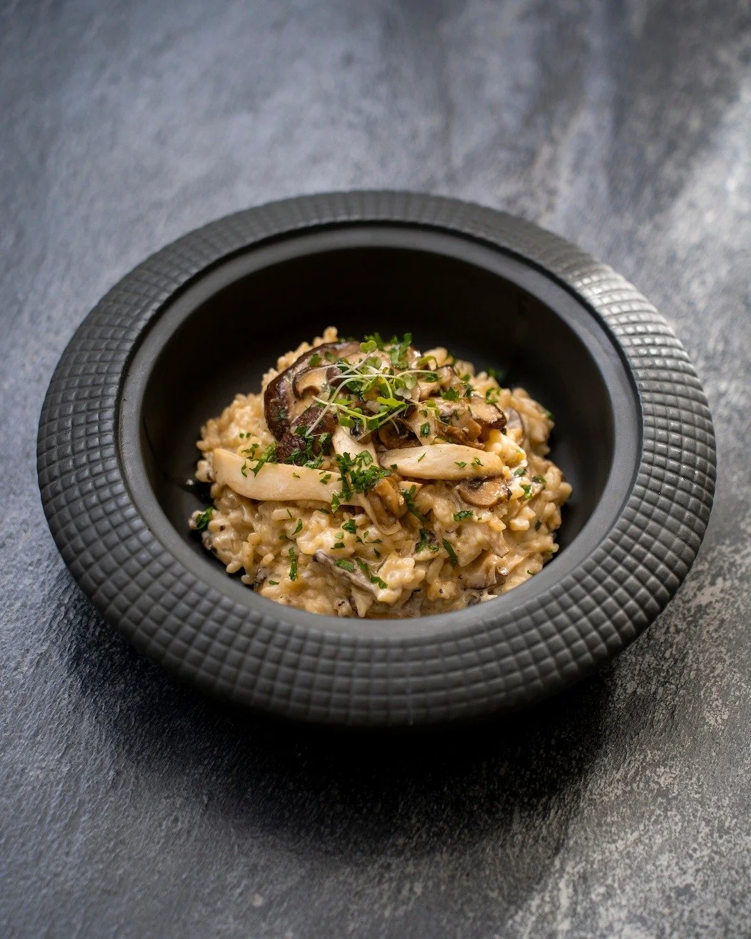 Worth the Truffle.

Italian porcini. Enoki. Shiitake. Grana Padano. White truffle oil. Black P&eacute;rigord truffle.

Put them together with perfectly creamy risotto and you get a dish that&rsquo;s wonderfully earthy, indulgent, and impossible to re