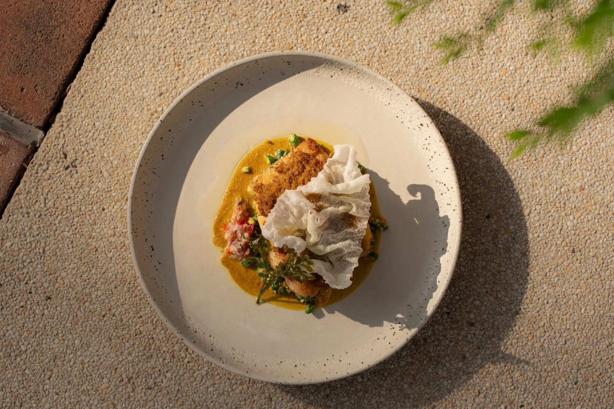 Fire meets fresh.

Our Charred Barramundi &lsquo;Ikan Bakar&rsquo; brings the smoky char of the grill together with crisp green beans, fragrant rice, and a punch of sambal matah.

A little fire. A lot of Indonesian flavor. 🔥

Book A Table
Call +6236
