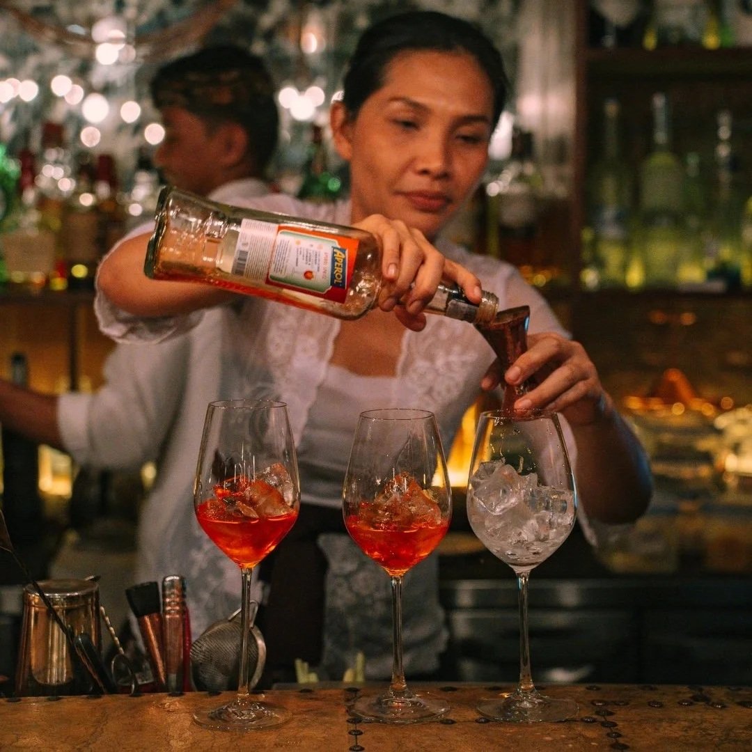 bartender making cocktails at copper rooftop bar