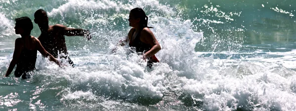 Playing in the waves on the beach in Jacmel, Haiti