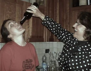 Mom feeding me the last drops of wine