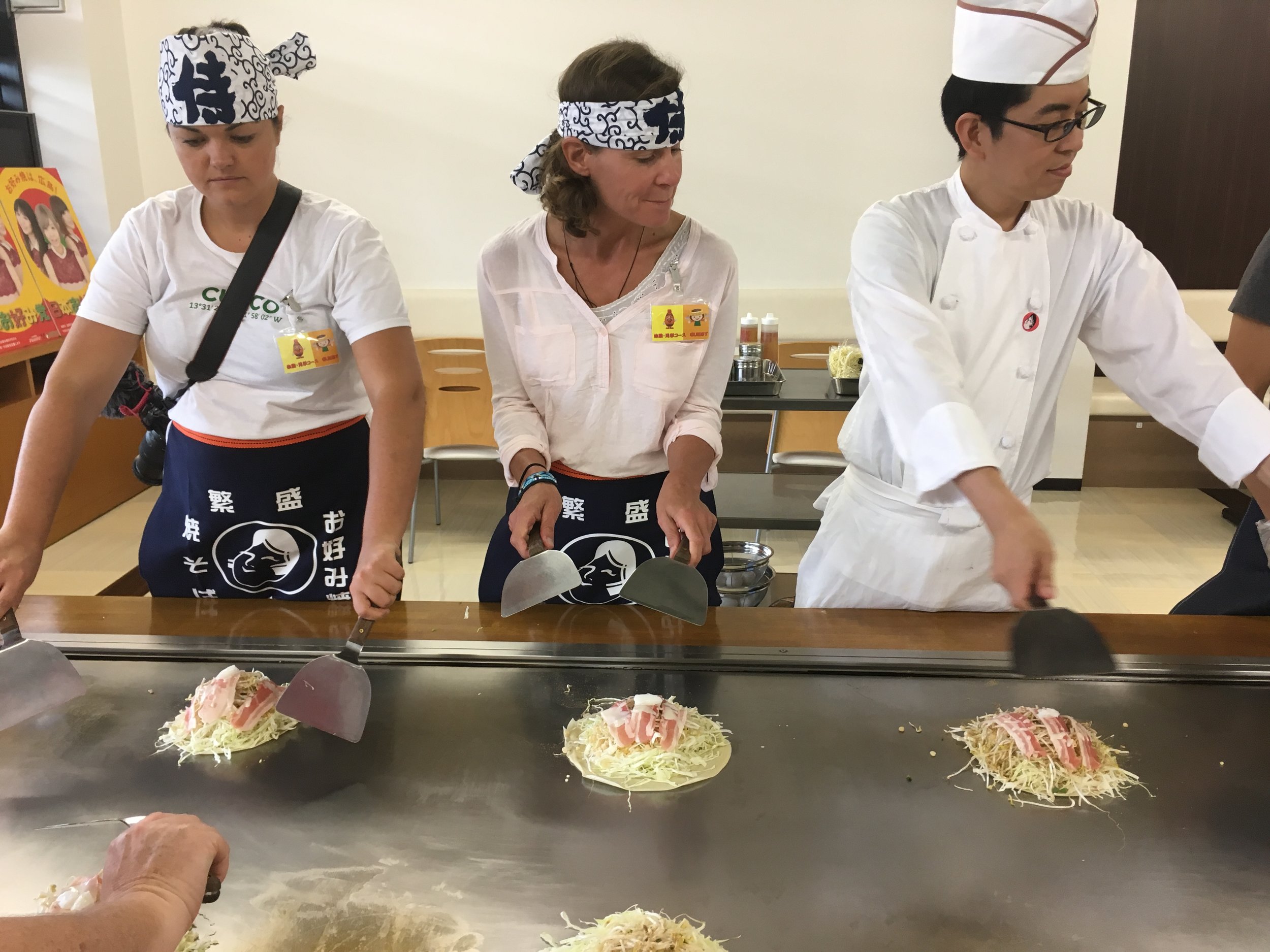 Practicing the art of okonomiyaki at the Otafuku factory