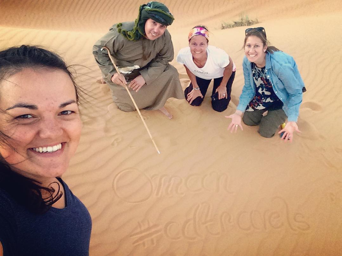 A team selfie while watching a desert sunset