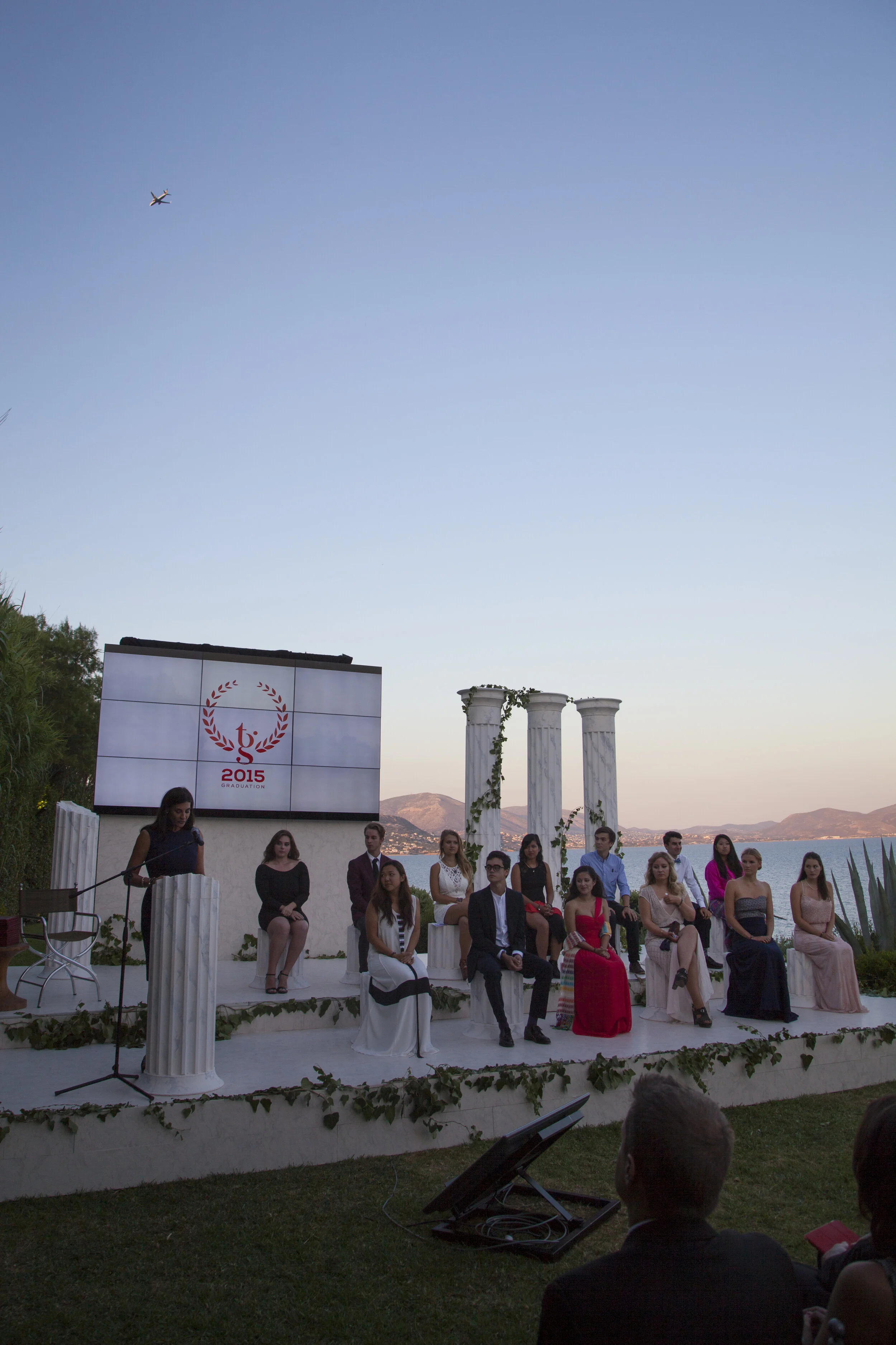 founder-joann-mcpike-speaks-to-the-graduates-as-a-plane-flies-over-athens-greece_19254978313_o.jpg
