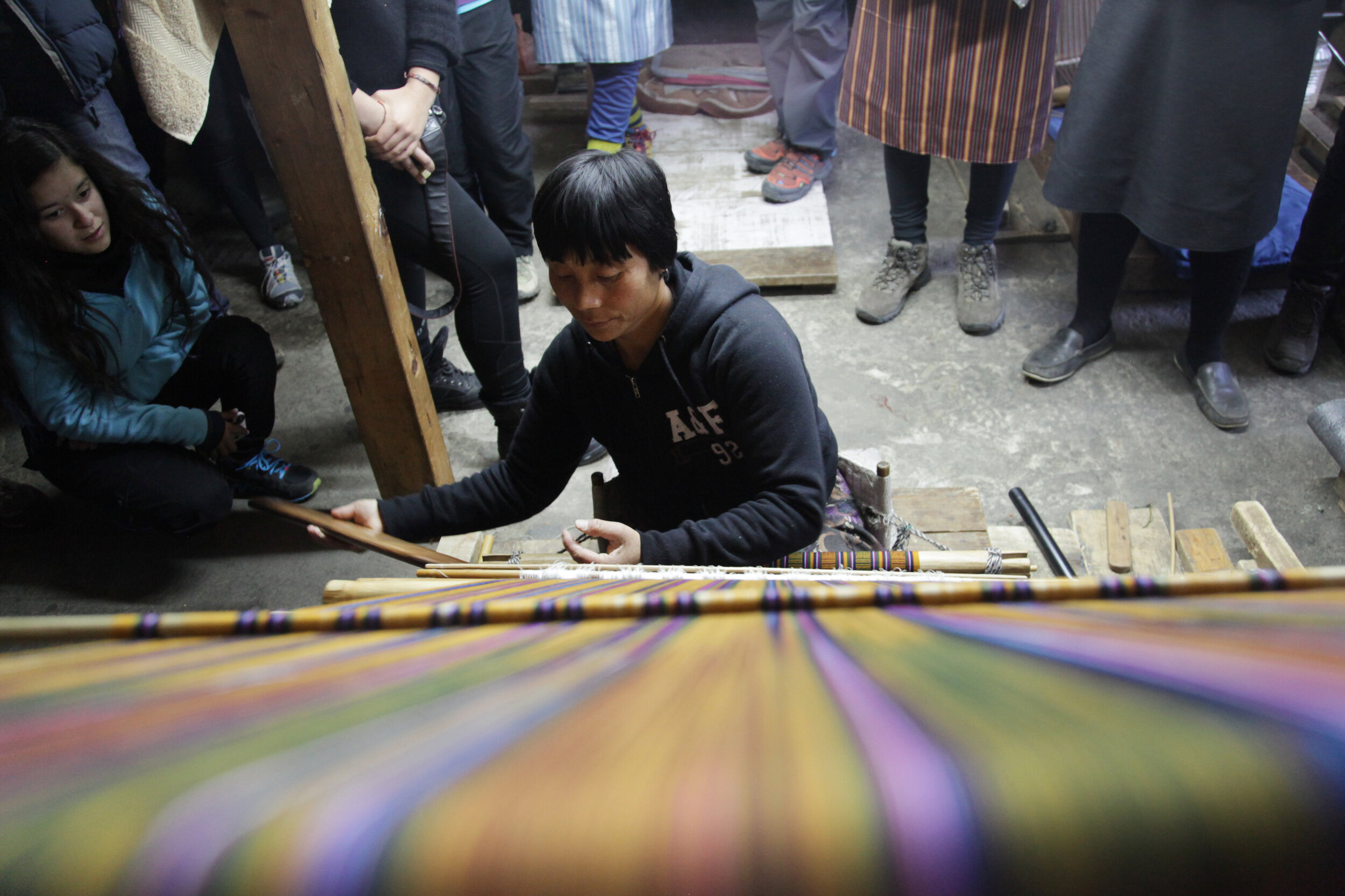woman-carefully-weaves-an-intricate-textile-to-make-the-traditional-kira-thimphu-bhutan_8398476784_o.jpg