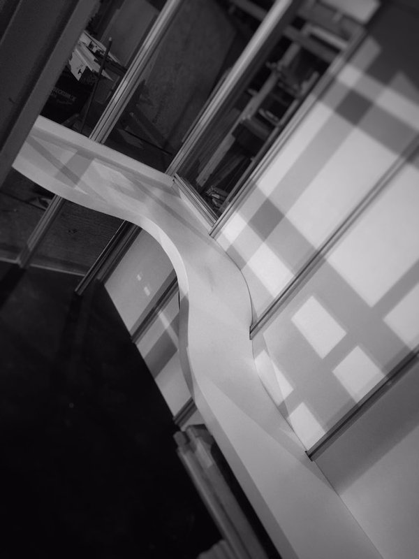 Desk that curves down into a bench
