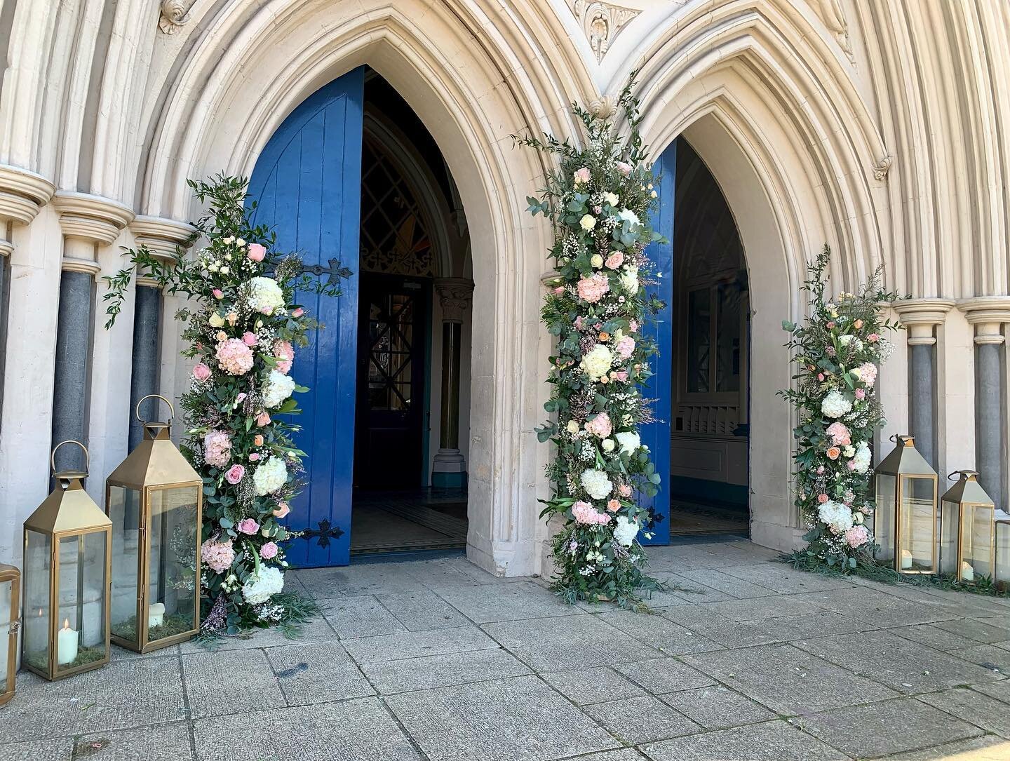 Floral pillars for St.Peter&rsquo;s Cathedral- 🌷🌸🤍so much to share- so little time #aprilwedding #cathedralwedding #churchflowers #ceremonyflowers #floralpillars #goldlanterns #tulips #roses #hydrangea #pinkpeachandwhite #irishwedding #niweddings 