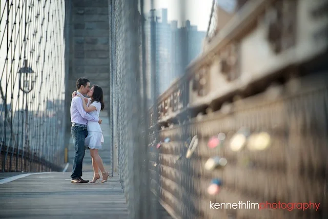 New York engagement photoshoot couple Brooklyn Bridge kissing